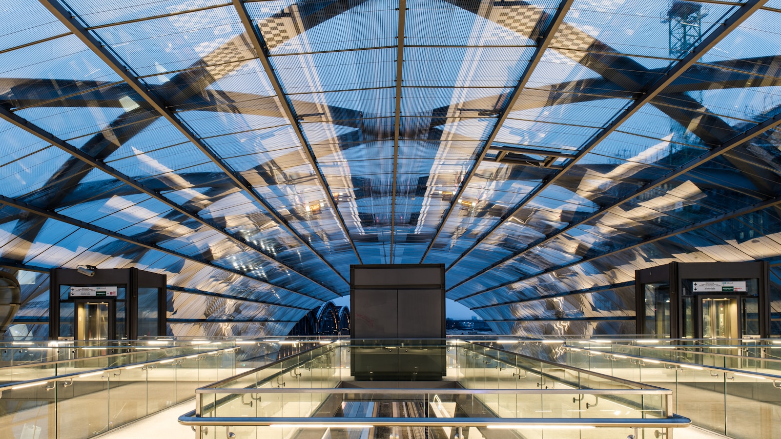 a glass ceiling in a building with a sky background