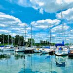 white and blue boats on sea under blue sky during daytime