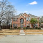 a brick house with a large front yard