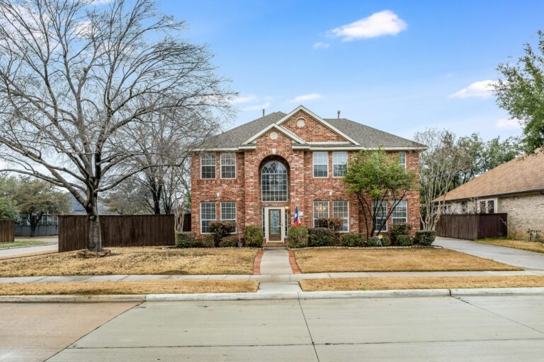 a brick house with a large front yard