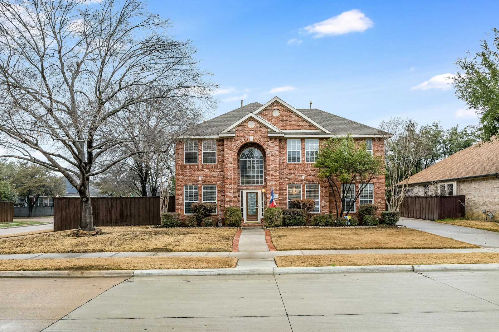a brick house with a large front yard