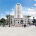 people walking on park near white concrete building during daytime